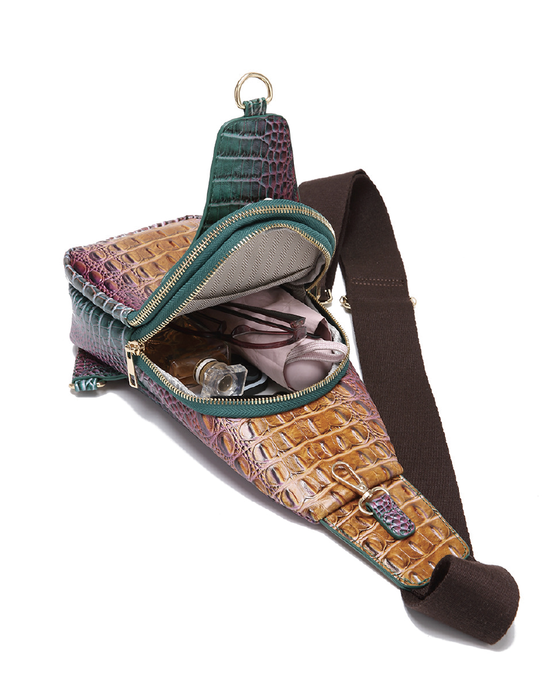Croc-embossed sling bag open with small accessories inside
