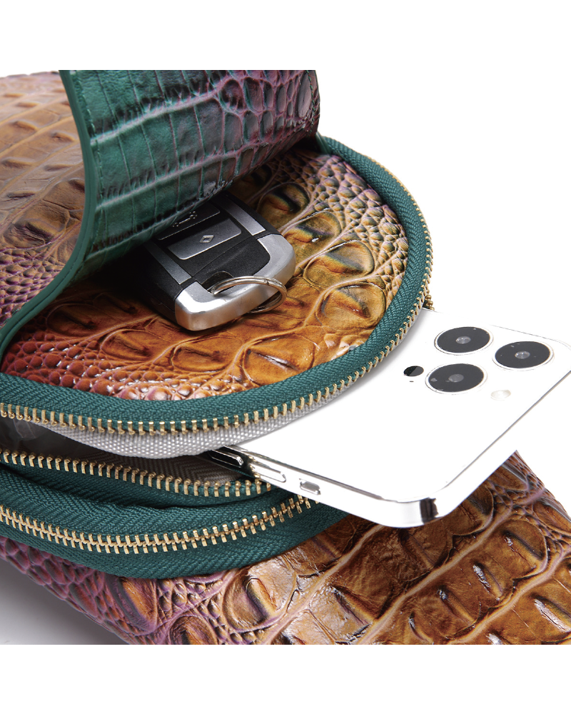 Croc-embossed sling bag open with phone inside