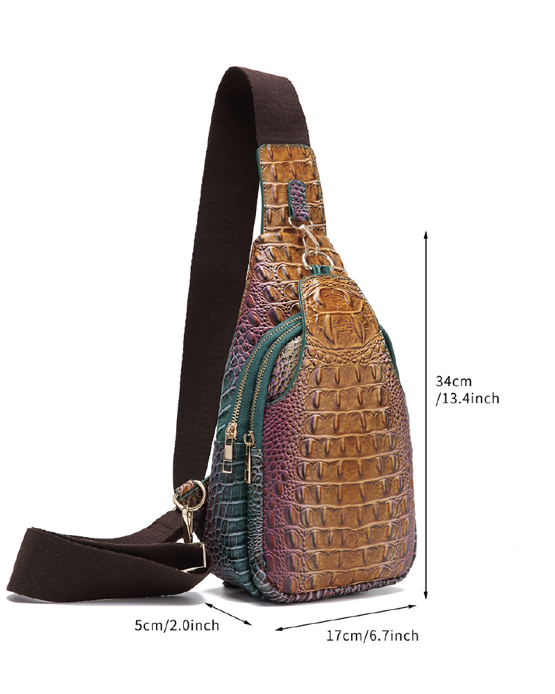 Croc-embossed sling bag worn across the back with dimensions