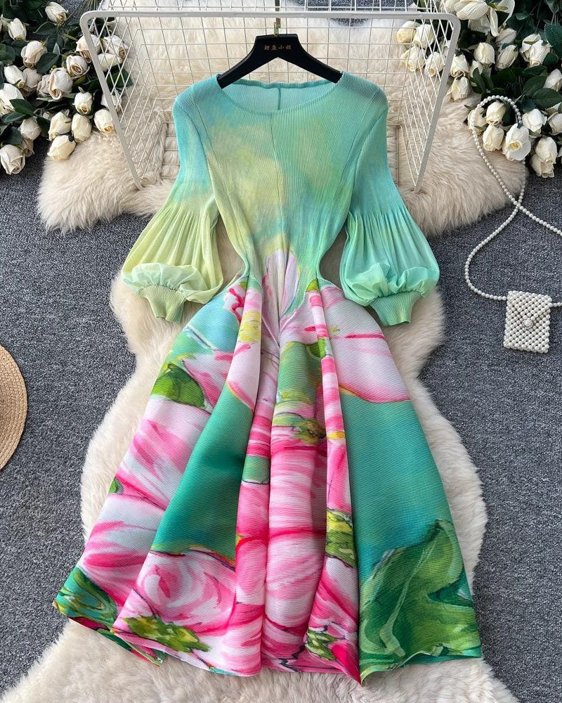 Green and pink floral pleated midi dress displayed on hanger