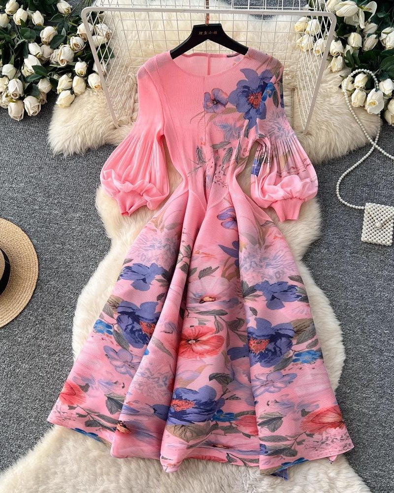 Pink and blue floral pleated midi dress displayed on hanger