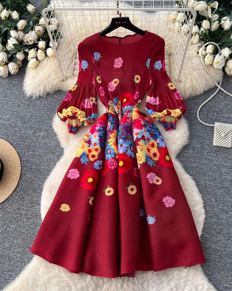 Burgundy floral pleated midi dress displayed on hanger
