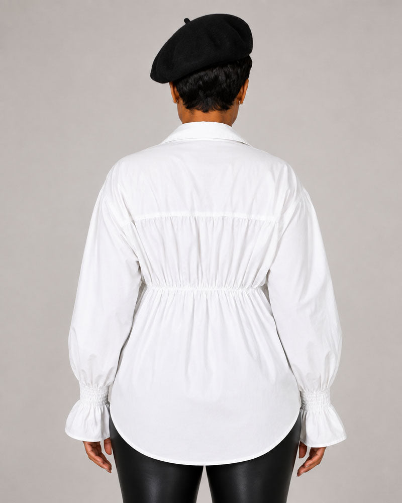 White shirt with gathered waist, back view