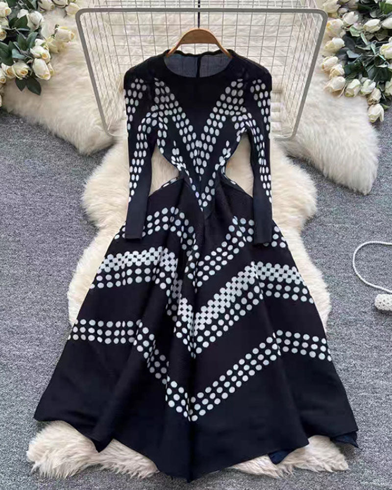 Black zigzag pleated maxi dress displayed on hanger