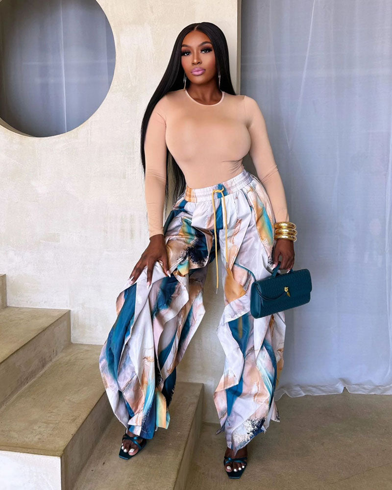 Blue abstract-print layered wide-leg jogger pants styled indoors