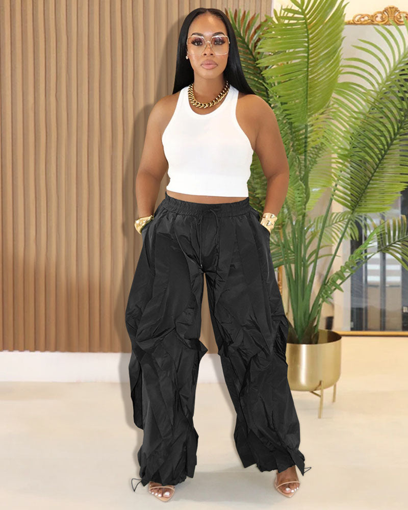 Black layered ruffle wide-leg jogger pants styled with white top