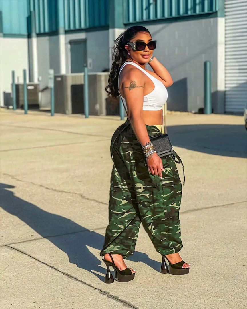 Army green camouflage harem overalls styled outdoors, side view