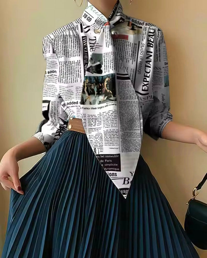 Newspaper-print oversized tie-front shirt styled with pleated skirt