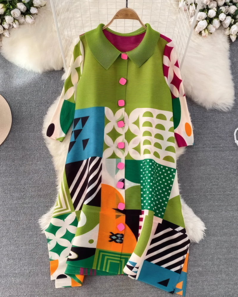 Green multicolor geometric pleated midi dress displayed on hanger