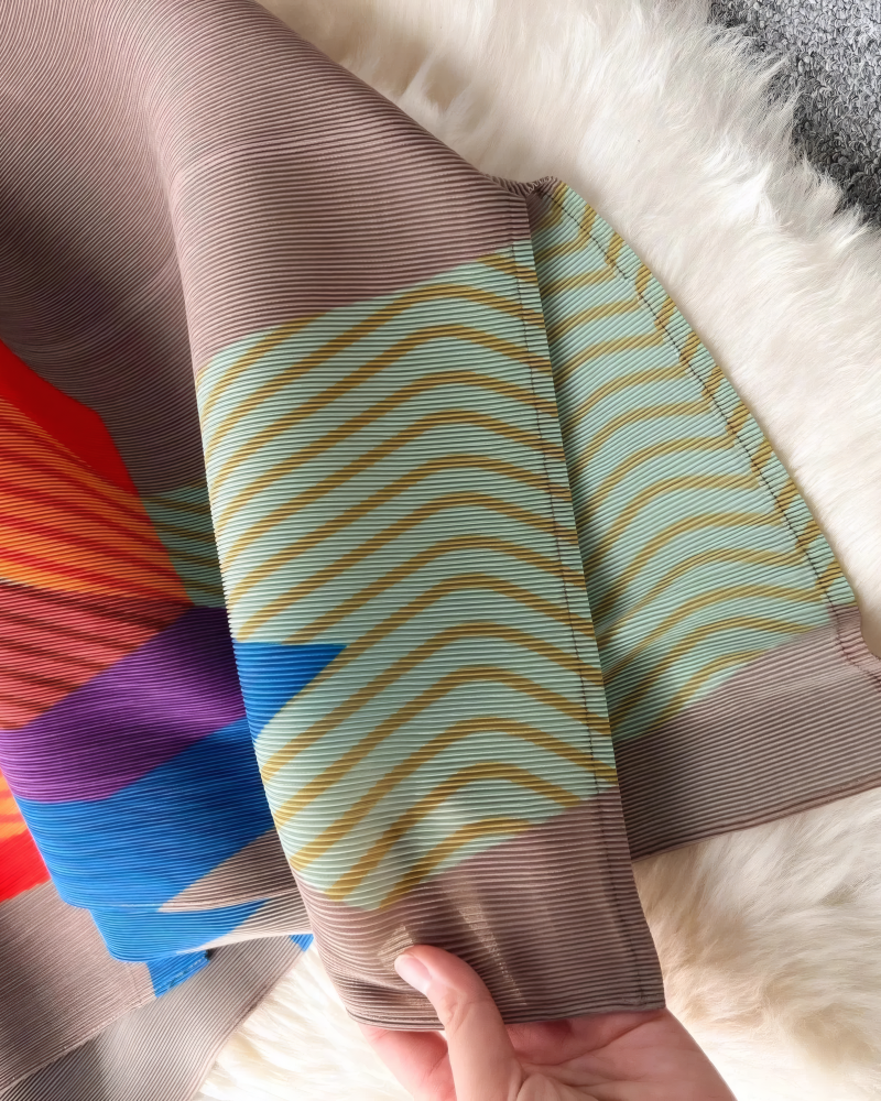 Green geometric pleated dress fabric detail